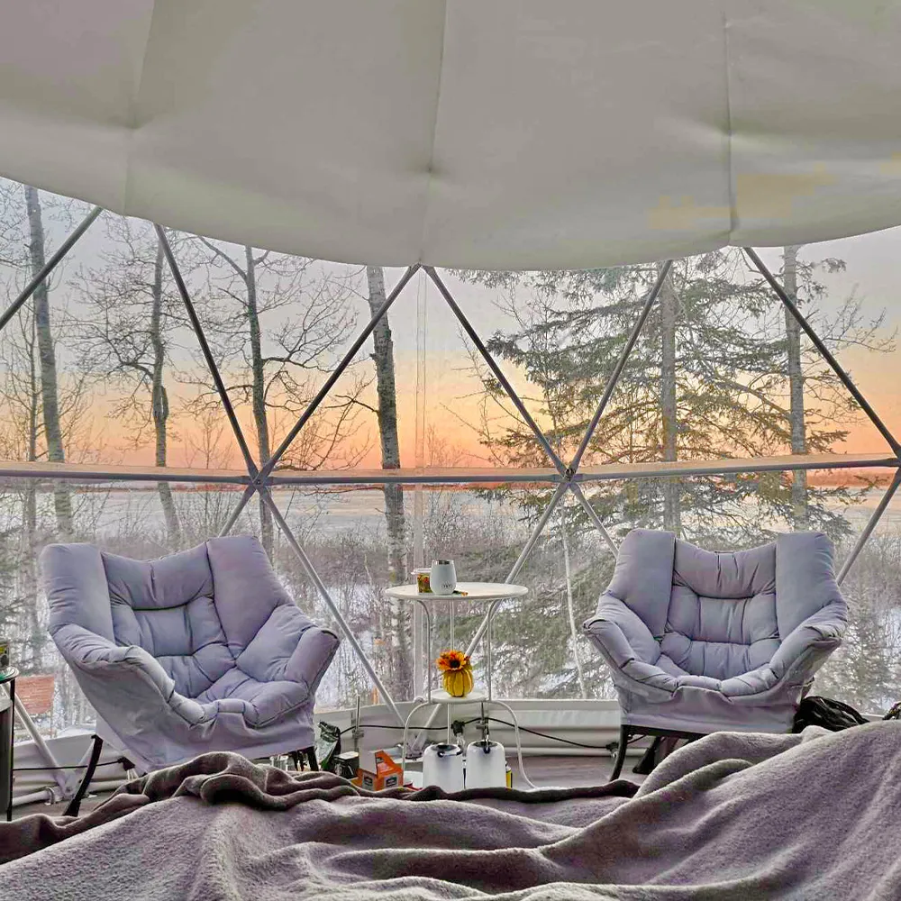 bed side view of interior of ignis dome with two lounge chairs