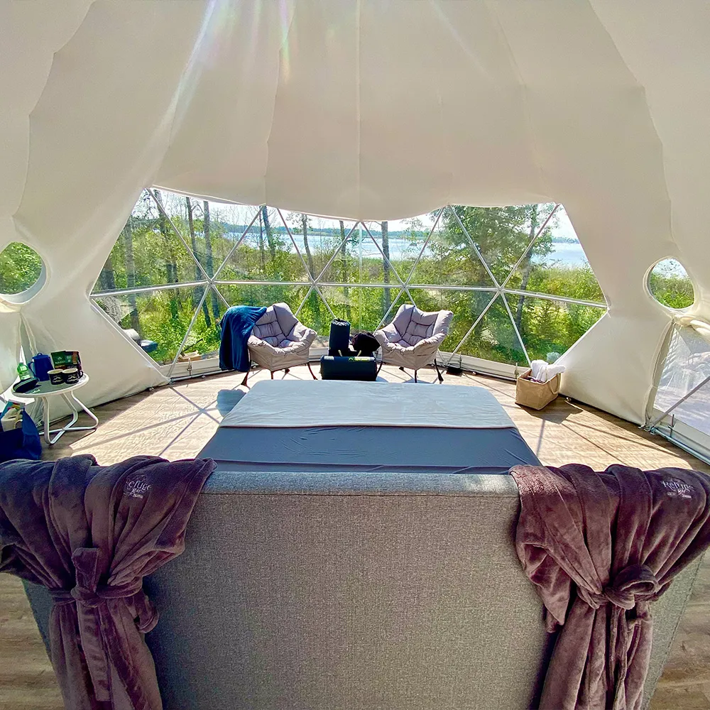 Interior shot of ignis dome during summer time with refuge bay robes hanging off the bed headboard for guests to use