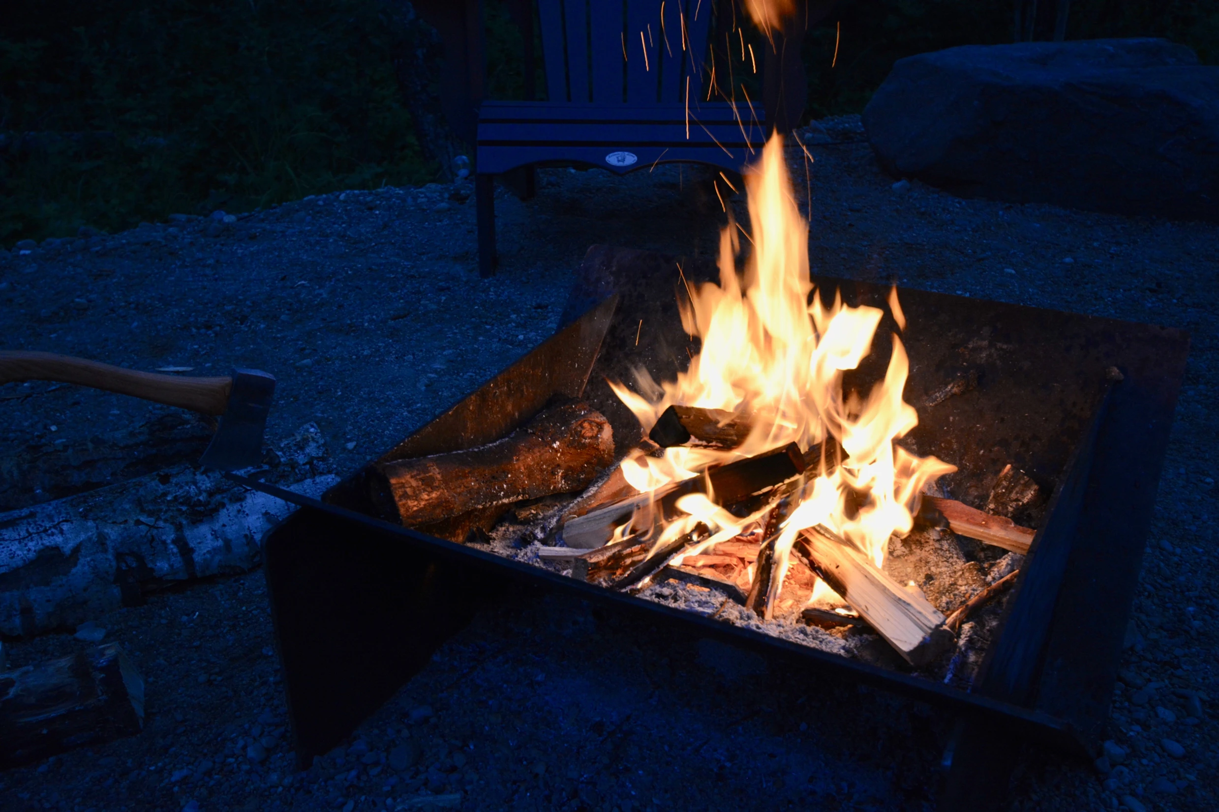 Large roaring flames in fire pit at night outside the ignis dome