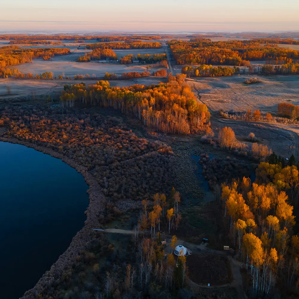 very wide angle birds eye view of ignis dome and nature, forest and lake during the evening