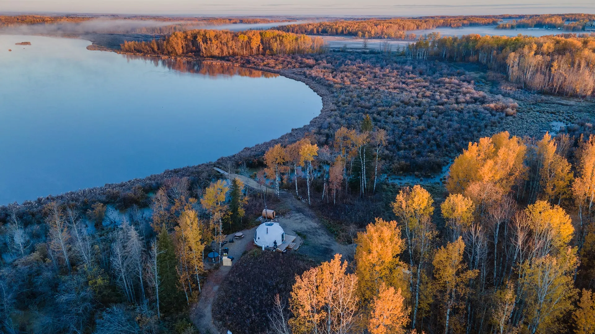 distance birds eye view of ignis dome with outdoor sauna and picnic table at alternative angle