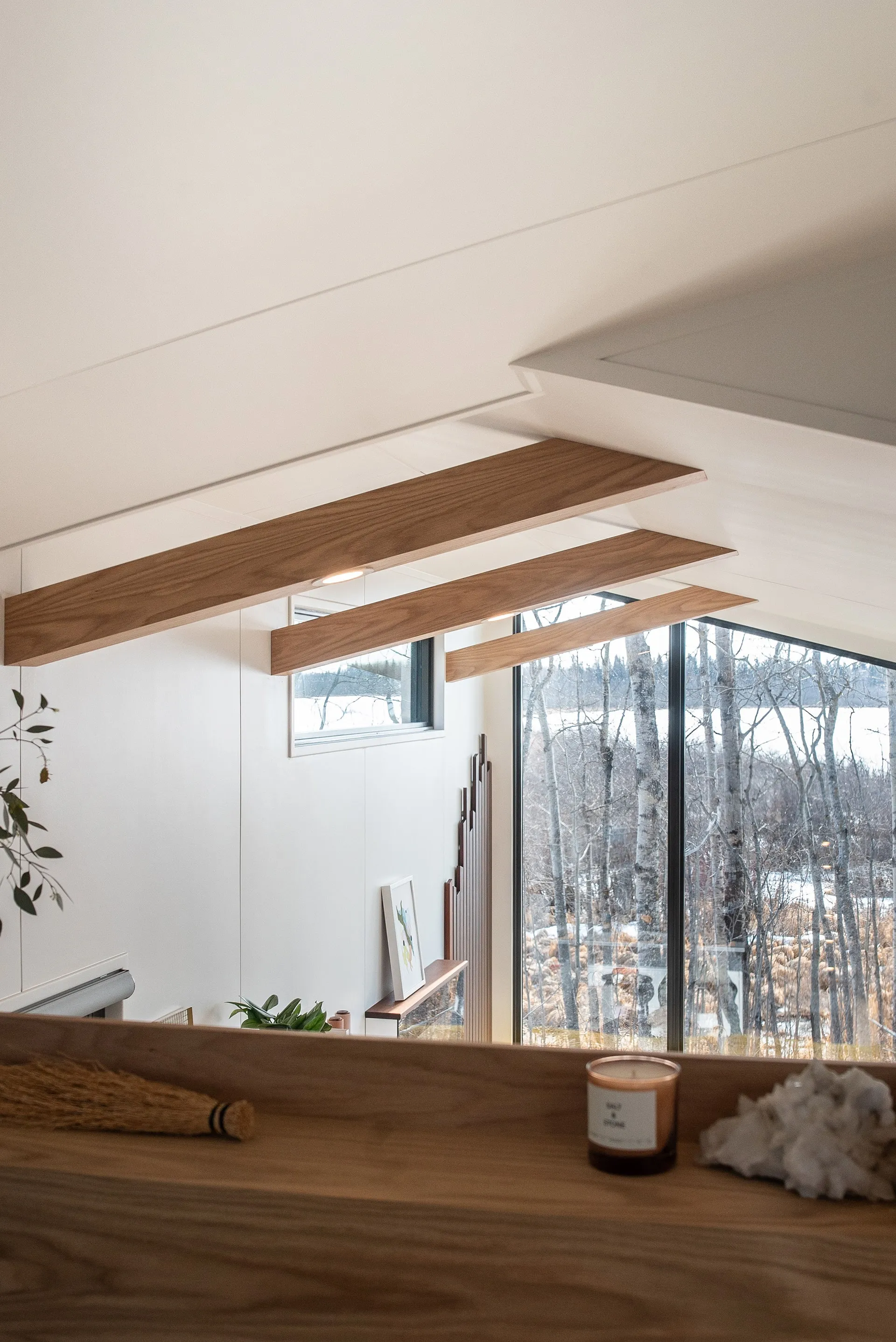 bed side view overlooking living room of aqua tiny home
